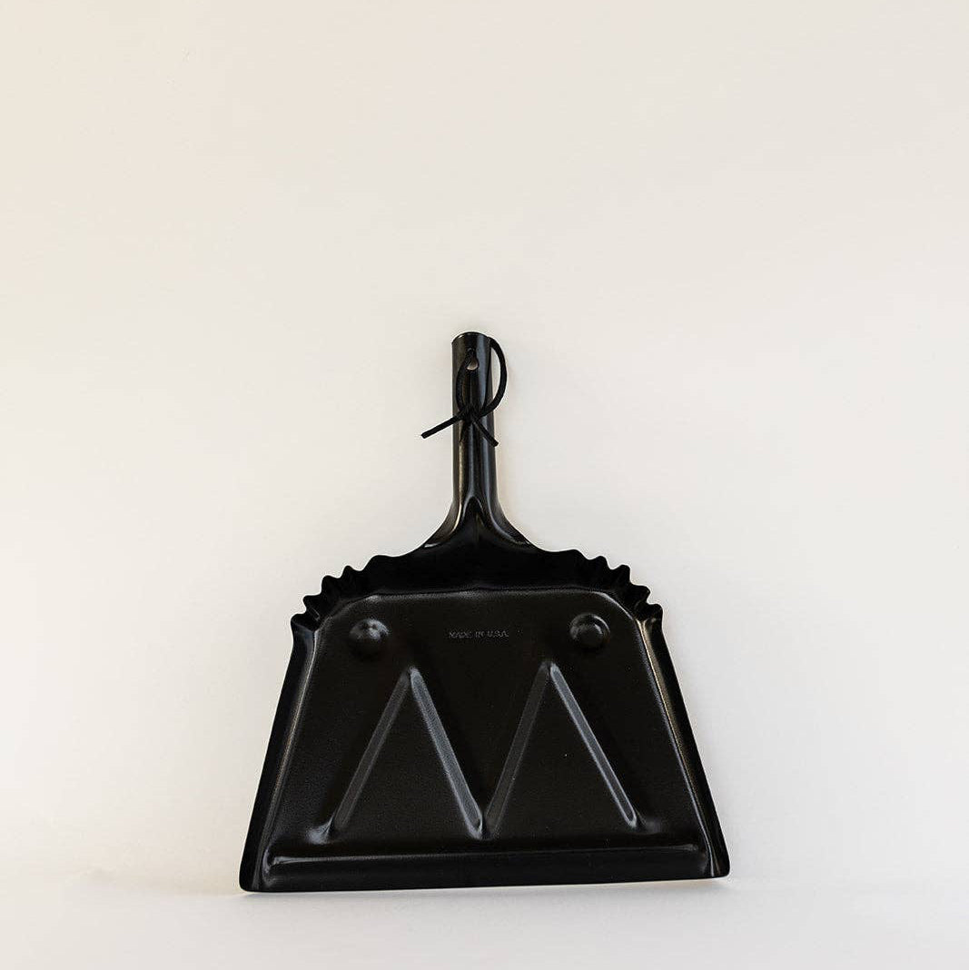 Front view of the black Farmhouse Dustpan showing its handle, hanging loop and wide edge.