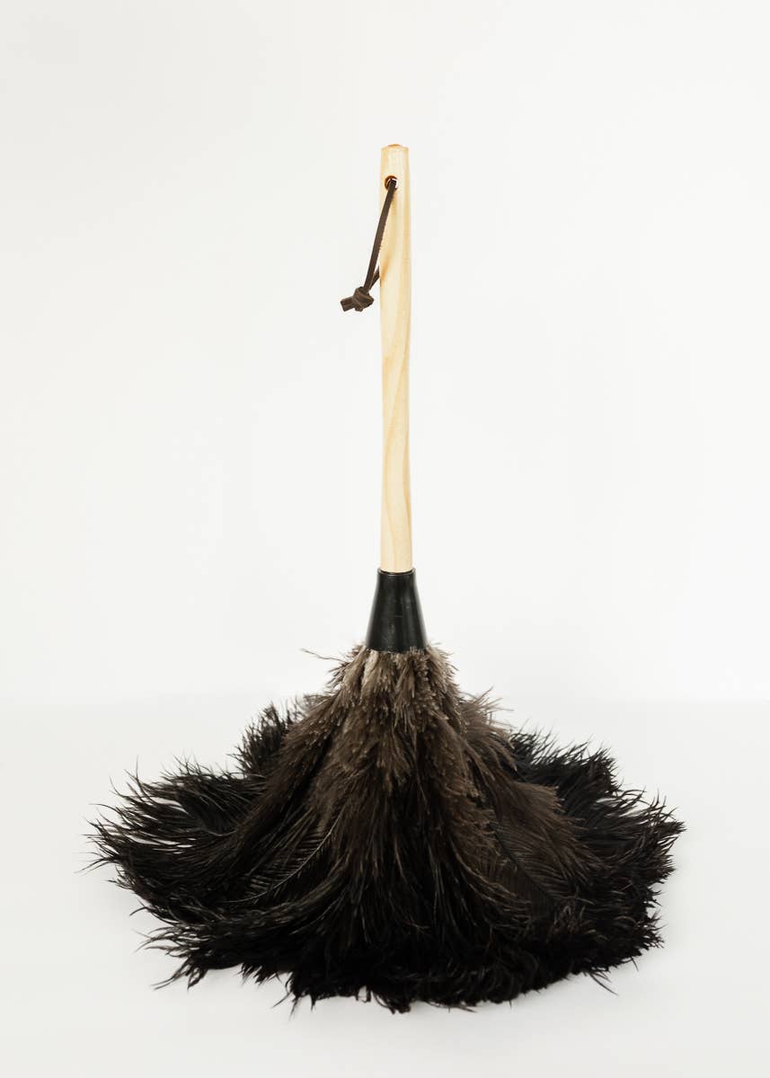 Full-length view of the feather duster with a wooden handle and leather hanging loop.