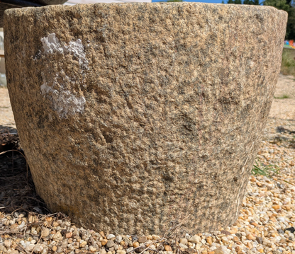 Front view of Brune Stone Mortar showing its rounded form and textured stone surface.