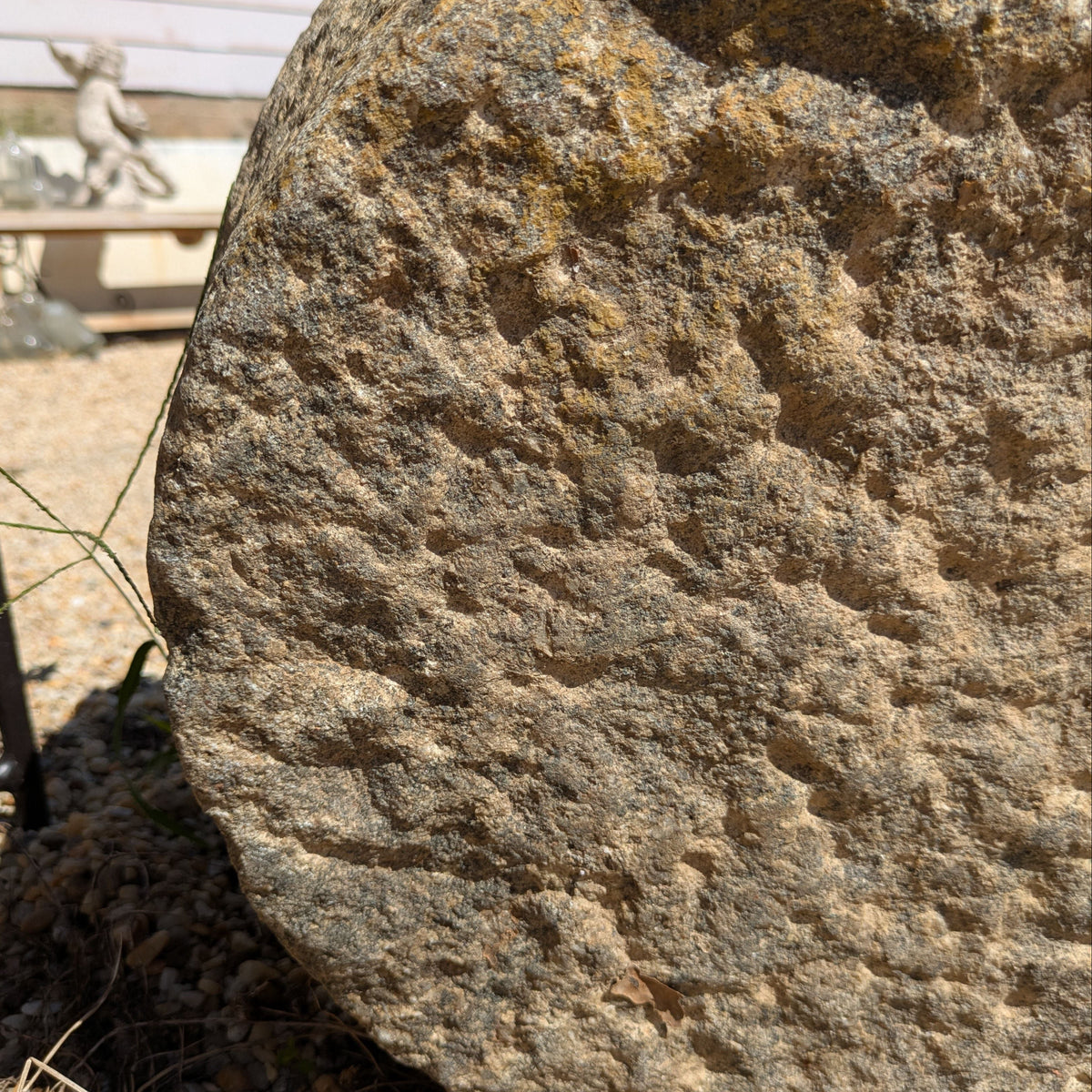 Close-up of Brune Stone Mortar's rough stone exterior in grey and brown tones.
