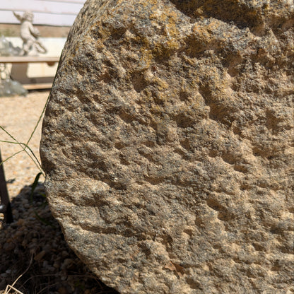 Close-up of Brune Stone Mortar's rough stone exterior in grey and brown tones.
