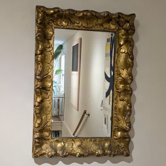 Aurèle Wall Mirror with a rectangular mirror and wide gold-toned scroll-and-leaf frame, mounted vertically.