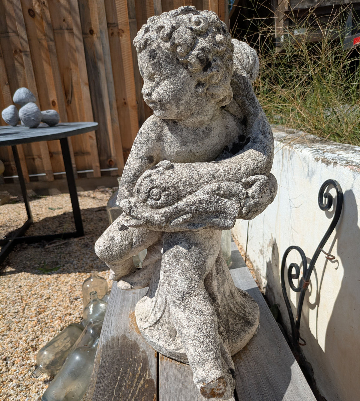 Front three-quarter view of Concrete Water Sprite showing the fish and textured grey surface.