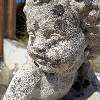 Close-up of Concrete Water Sprite's face and curly hair, showing the rough surface texture.