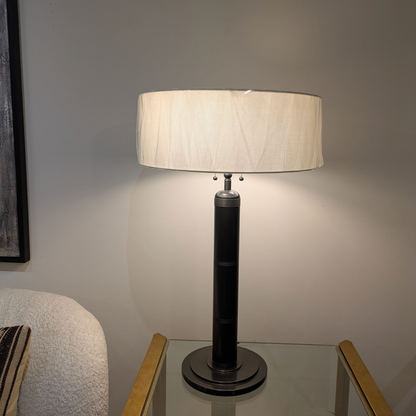 Longacre bronze table lamp photographed in the shop beside a chair, with corrected perspective.
