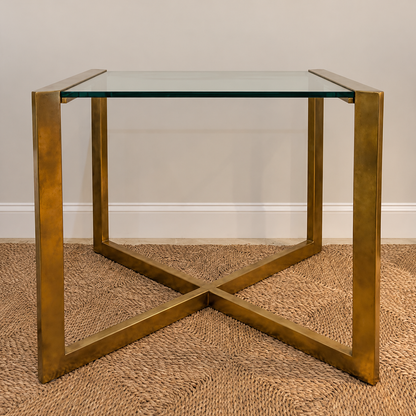 Varenne glass side table with a gold-toned metal frame and crossed lower stretchers.